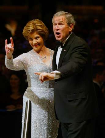George W. and Laura Bush, a Freemason and a member of the Bohemian Club and Skull and Bones,
		showing the Satanic sign of Horned Hand or The Mano Cornuto